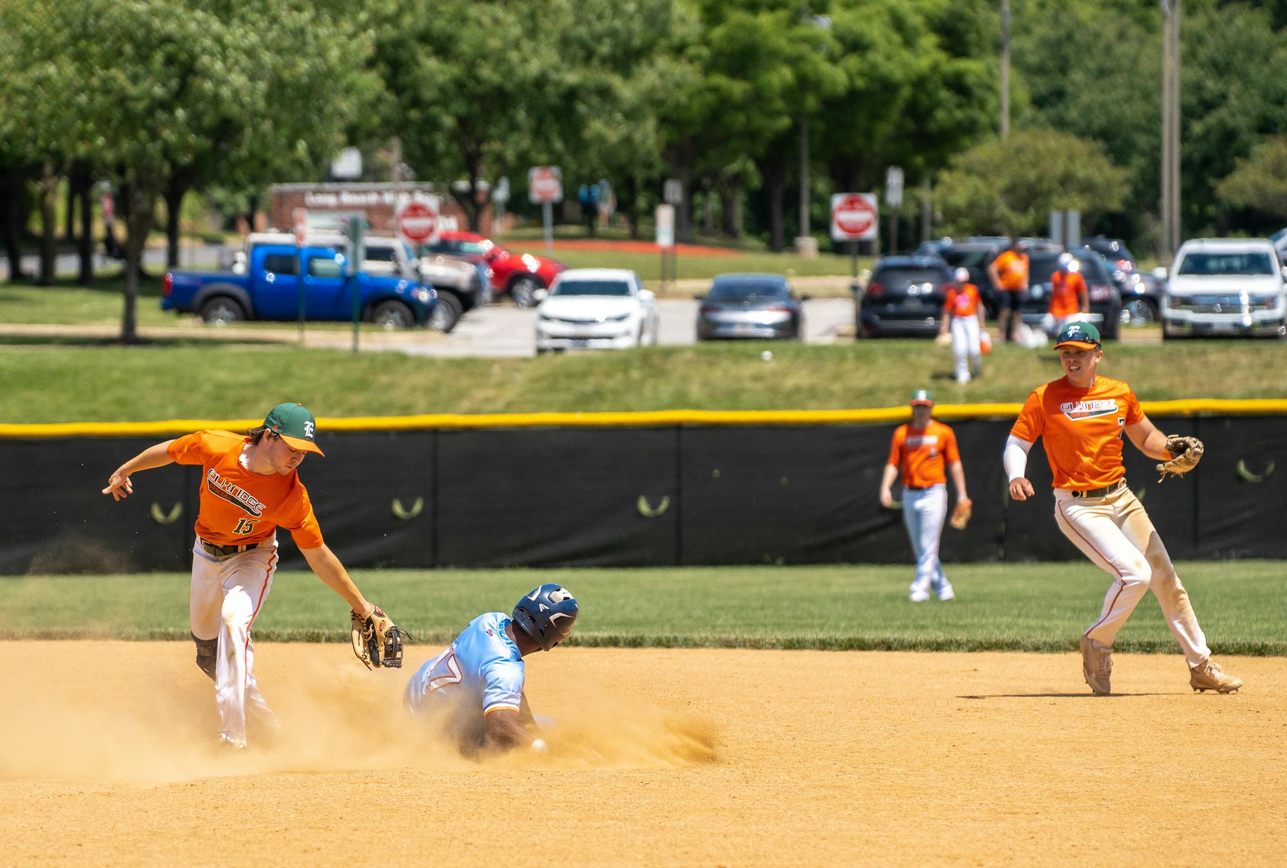 Exciting baseball game moment with athletes playing energetically on a sunny field in Columbia, MD.
