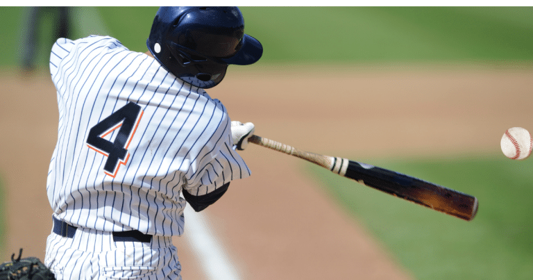 canva: Young batter swinging at pitch